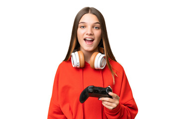 Canvas Print - Teenager caucasian girl playing with a video game controller over isolated background with surprise facial expression