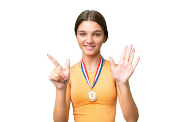 Poster - Teenager caucasian girl with medals over isolated background counting seven with fingers