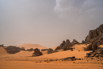 Wall Mural - iew in the Sahara desert of Tadrart rouge tassili najer in Djanet City  ,Algeria.colorful orange sand, rocky mountains