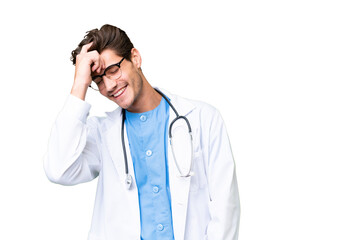 Wall Mural - Young doctor man over isolated background laughing