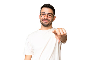 Young handsome caucasian man over isolated chroma key background pointing front with happy expression