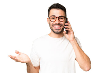 young handsome caucasian man over isolated chroma key background keeping a conversation with the mob