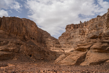 Wall Mural - iew in the Sahara desert of Tadrart rouge tassili najer in Djanet City  ,Algeria.colorful orange sand, rocky mountains