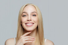 Beautiful Blonde Woman Touching Her Face Her Hand. Pretty Candid Female Model. Facial Treatment, Face Lifting, Anti Aging And Skin Care Concept