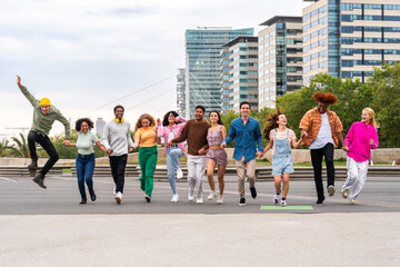 happy playful multiethnic group of young friends bonding outdoors - multiracial millennials students