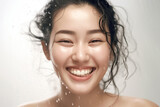 Fototapeta  - Vitality of this stunning close-up shot, where a captivating Asian girl's radiant smile is accentuated by playful water droplets and splashes, evoking a sense of pure delight. Generative AI.