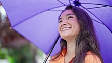 Young Beautiful Hispanic Woman Smiling Confident Holding Umbrella At Park