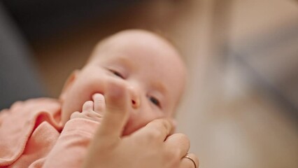 Sticker - Mother and daughter sitting on sofa touching nose with finger at home