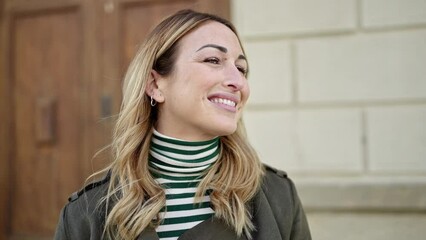 Wall Mural - Young beautiful hispanic woman smiling confident at street