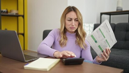 Poster - Young beautiful hispanic woman using laptop doing accounting at home