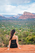© travnikovstudio - Young hiker woman on the edge of a cliff at Cathedral Rock in Sedona, Arizona. View from Scenic Cathedral Rock in Sedona with blue sky in Arizona