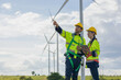© Quality Stock Arts - Engineer team man and woman field working together survey plan construction wind turbine clean power generator