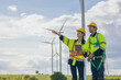© Quality Stock Arts - Engineer team man and woman field working together survey plan construction wind turbine clean power generator