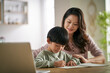 © imtmphoto - young asian mother helping son with homework