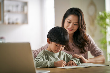 Wall Mural - young asian mother helping son with homework