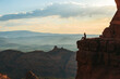 © travnikovstudio - Young hiker woman on the edge of a cliff at Cathedral Rock in Sedona, Arizona. View from Scenic Cathedral Rock in Sedona with blue sky in Arizona