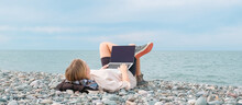 Remote Work.Girl Freelancer Works Remotely On The Sea Shore. Workation, Remote Work,WFVH,Van Life Vibes Work From Vacation Home,work Travel,remotely Work.Travelling.Work From Vacation Remotely