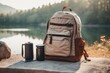 © Yuliia - Lightweight brown backpack tourist cup can jar beautiful natural lake forest mountains hills background adventure summer hiking camping travelling trip tourism expedition healthy active leisure time
