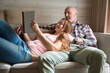 © Svitlana - Joyful female and her focused spouse reading novel together