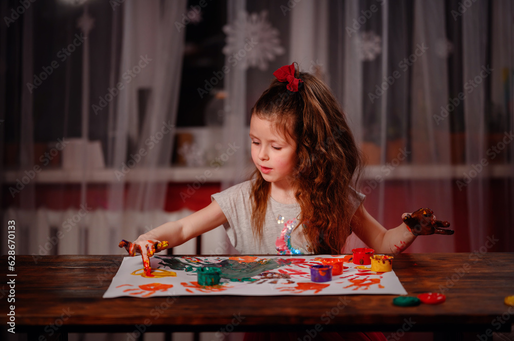 Cute little girl painting with fingers at home. Creative games for kids ...