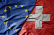 © luzitanija - big waving realistic national colorful flag of european union and national flag of switzerland .