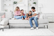 © New Africa - Happy family having fun together on sofa at home