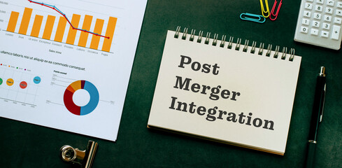 there is notebook with the word post merger integration. it is as an eye-catching image.