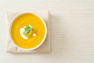 Wall Mural - pumpkin soup in white bowl