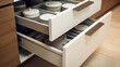 The open kitchen drawer reveals a well-organized collection of plates, showcasing a clever solution for kitchen storage and organization.