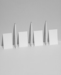 Wall Mural - White business cards and pens on a white background with shadow. Creative layout. Minimal business mockup