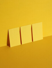 Wall Mural - Yellow business cards on yellow background with shadow. Creative layout