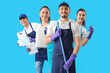 © Pixel-Shot - Young janitors with cleaning supplies on blue background