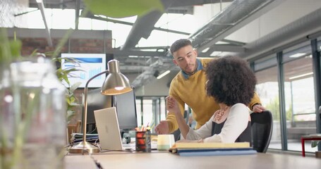 Wall Mural - diverse man and woman discussing over a computer at office
