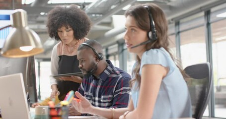 Wall Mural - happy diverse businesspeople discussing over a computer at an office