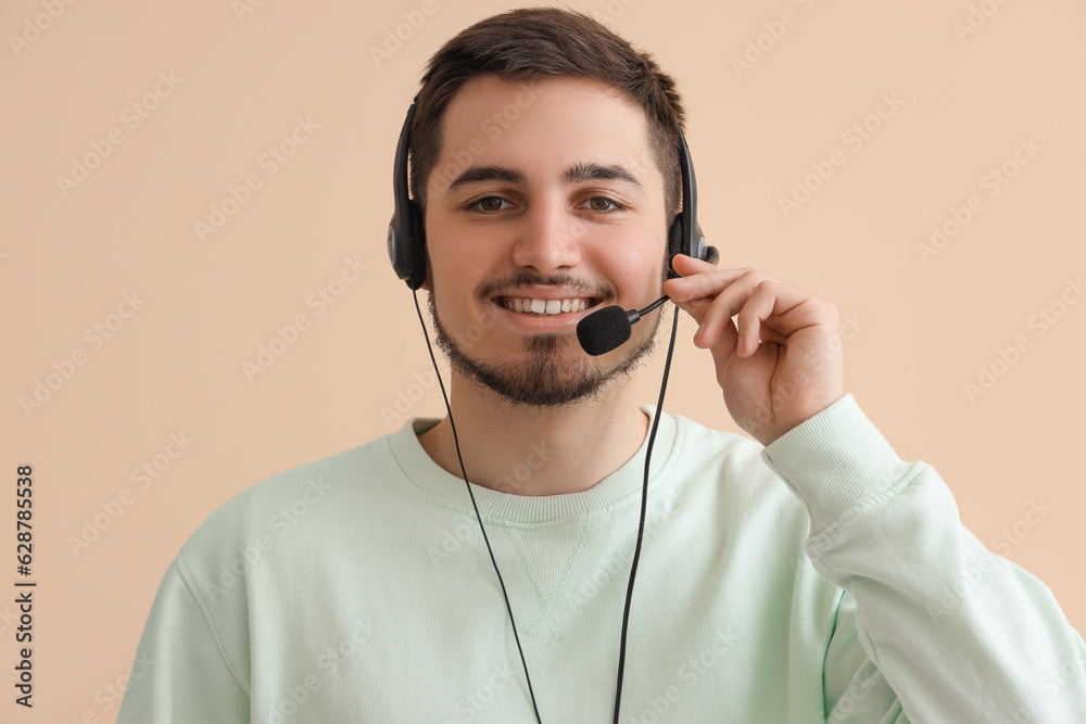 Male technical support agent on beige background