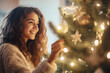  Beautiful young woman decorating a Christmas tree