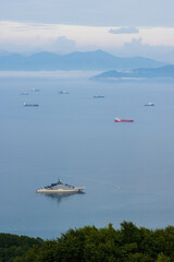  Beautiful morning seascape. View from the hill to the ships in the roadstead in the bay. Mountains in the distance. Avacha Bay, Petropavlovsk-Kamchatsky, Kamchatka Territory, Far East of Russia.