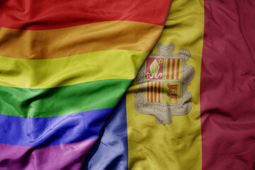 big waving realistic national colorful flag of andorra and rainbow gay pride flag .