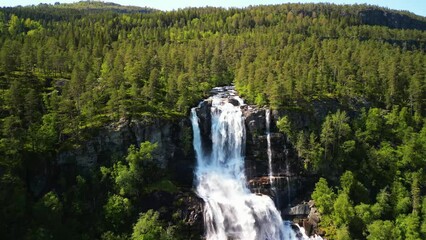 Sticker - Drone view over Tvindefossen waterfall with green lush forest view on a sunny day