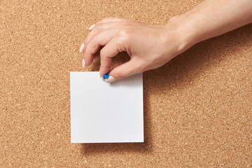 Sticker - Female hand attaches an empty note to a cork board