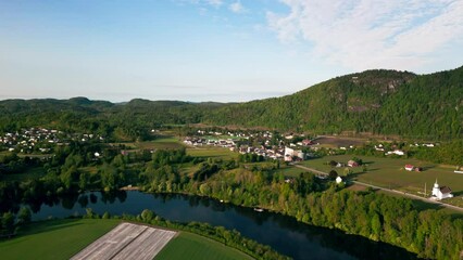 Poster - Beautiful drone footage over rural countryside houses on lawns and a river with hills in Norway