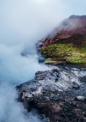 Sticker - expansive mountain range and a lake with steam rising from it, Reykjavik, Iceland