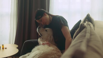 Poster - Beautiful girl lazily playing with her golden retriever on the couch