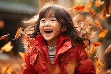 Close Up Of Little Asian Girl Child Playing In Autumn Fall Leaves Red Jacket