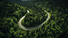 Aerial View Of A Road In The Middle Of The Green Forest , Road Curve Up To Mountain. Travel With Car Concept.