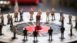 © Philipp - Miniature business figures are positioned on a strategic board game, with a central figure highlighted, symbolizing leadership, teamwork, and strategic decision-making in business.