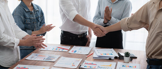 Leinwandbilder - Analyst team celebrates successful data analysis with handshake. Panorama shot handshaking after adjusting attitude or brainstorm for future success in meeting room with BI dashboard paper. Scrutinize