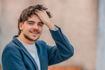 young male looking at bed with hand in hair