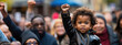 Black baby, kid with fist raised, black history month concept, african american boy, copyspace, blank space for text, inclusivity and diversity, protest