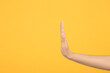 Woman showing stop gesture on orange background, closeup. Space for text